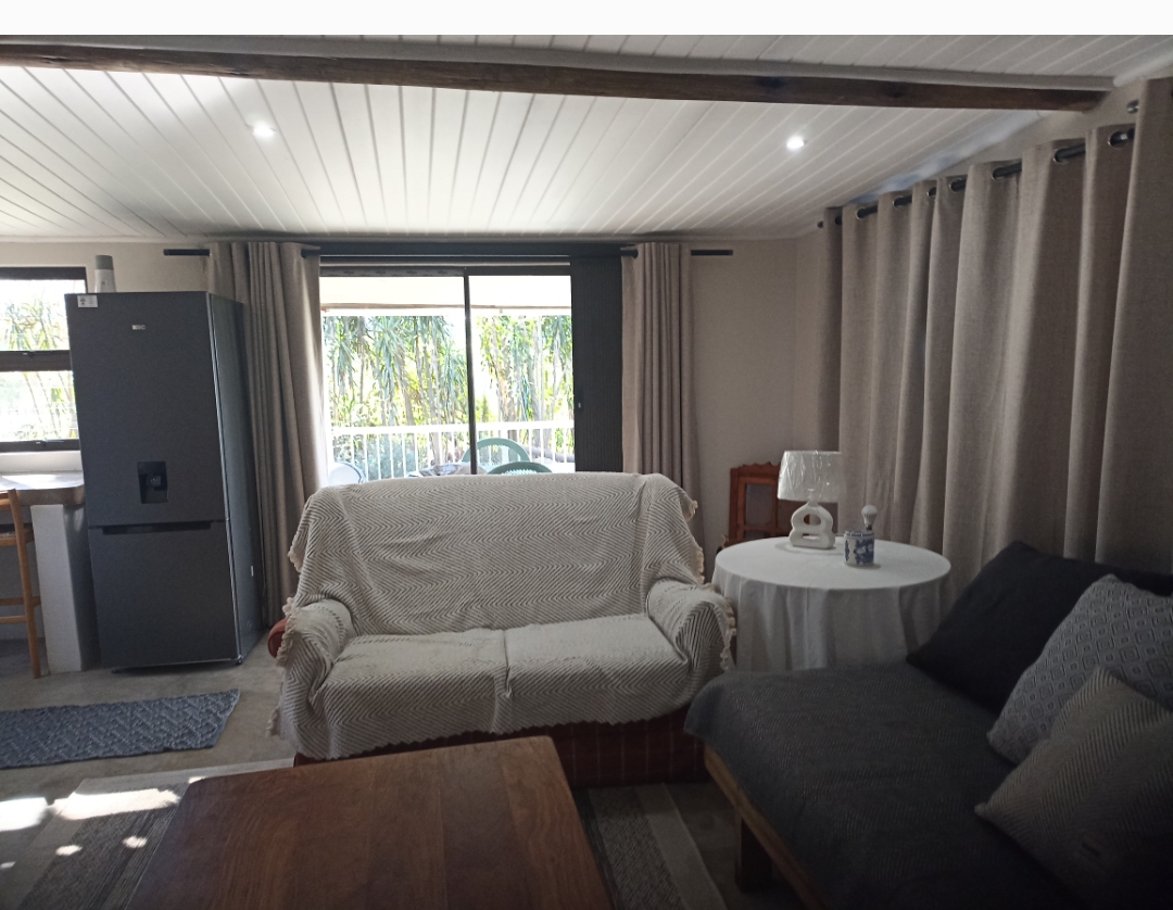 Holly Cottage lounge with patio doors opening to the farm